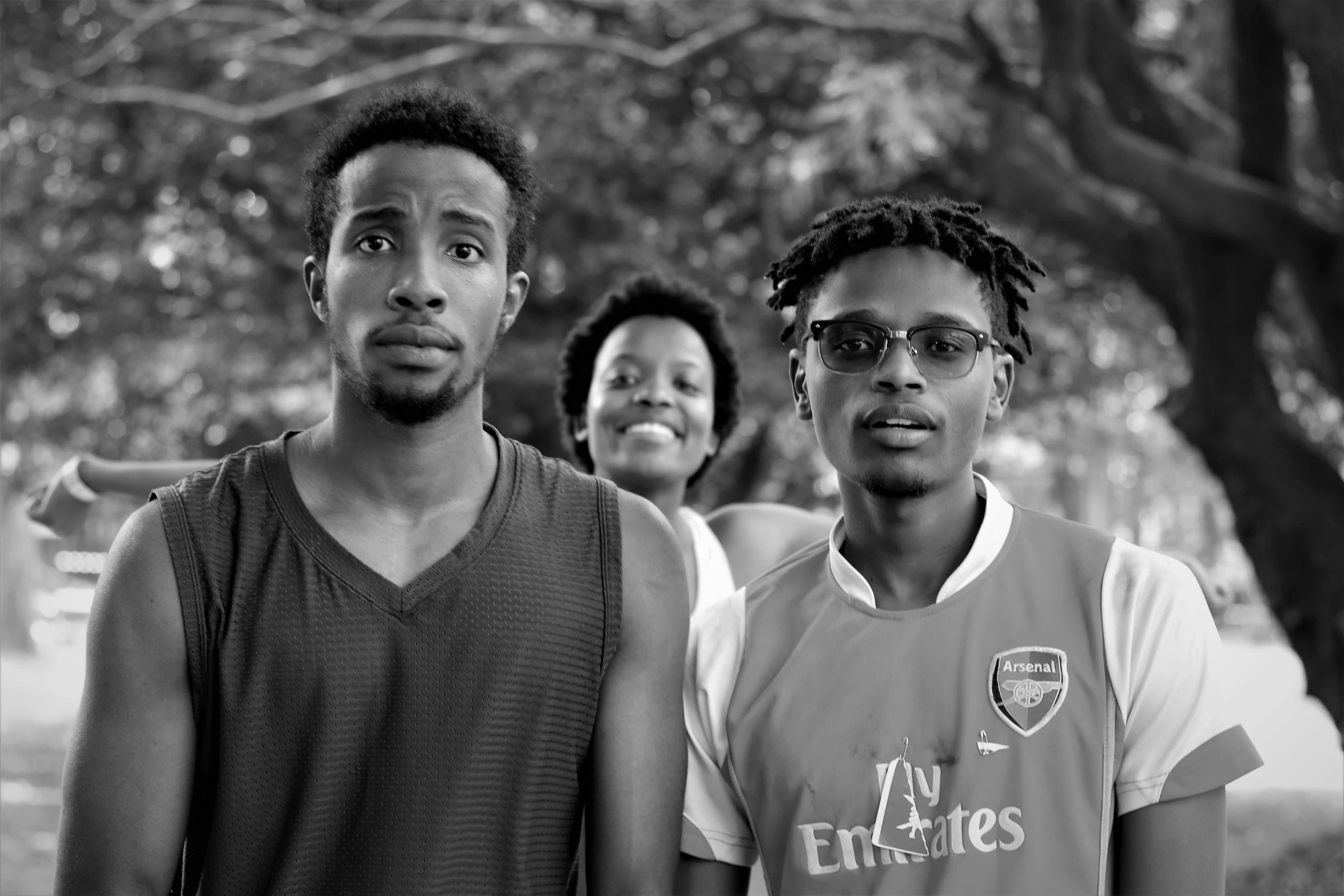 a group of young men standing next to each other, a black and white photo, inspired by Willian Murai, pexels, black arts movement, of a family standing in a park, african facial features, sport, unsplash contest winning photo