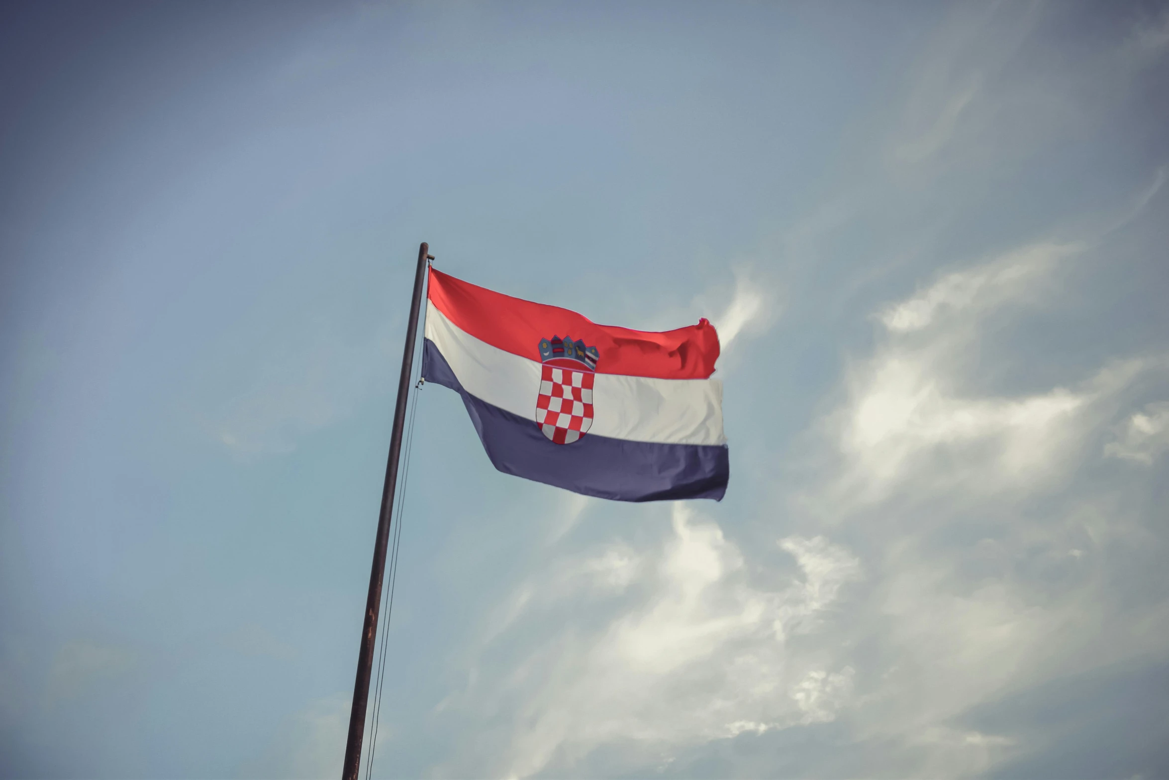 a red, white and blue flag flying in the sky, by Matija Jama, unsplash, hurufiyya, square, viktor orban, brown, croatian coastline