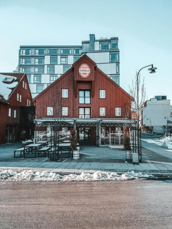 a red building sitting on the side of a road, by Constantin Hansen, pexels contest winner, scandinavian / norse influenced, restaurant exterior photography, sunny winter day, thumbnail