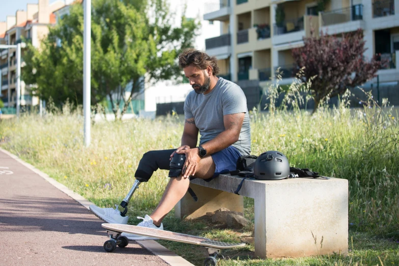 a man sitting on a bench next to a skateboard, by Cricorps Grégoire, using a exoskeleton, gray, exclusive, black