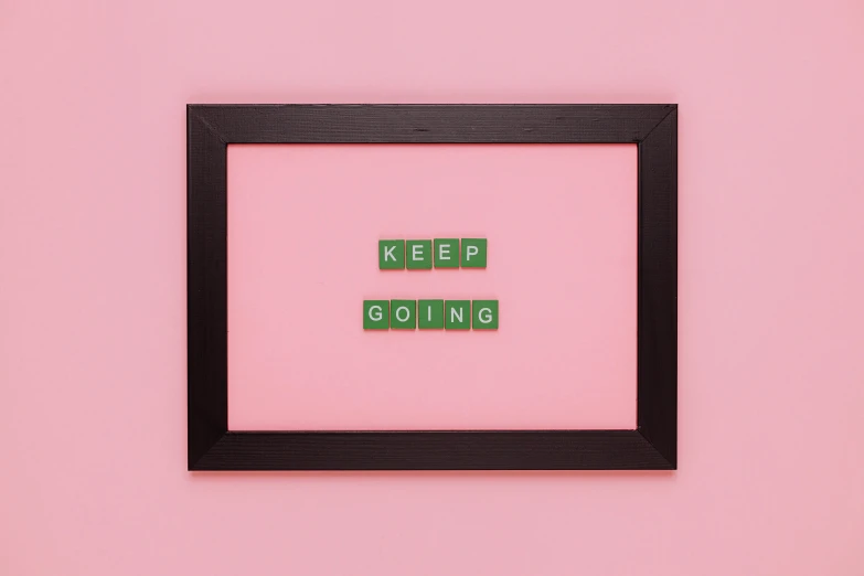 a pink wall with a black frame that says keep going, thumbnail, tiling, mint, knolling
