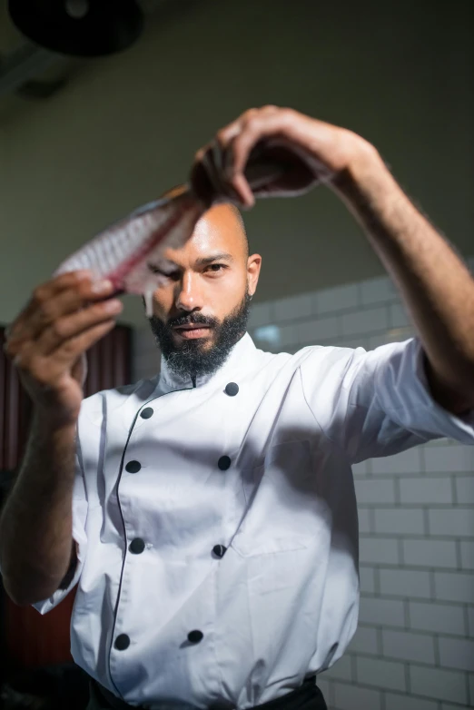 a man standing in a kitchen holding a comb, inspired by Nadim Karam, pexels contest winner, chefs table, headshot profile picture, thumbnail, multiple stories