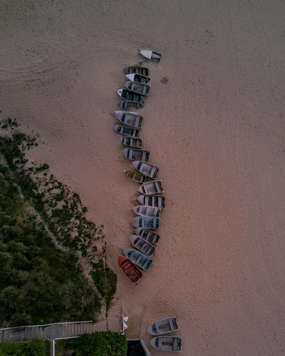 a group of boats sitting on top of a sandy beach, by Attila Meszlenyi, unsplash contest winner, land art, parked cars, abel tasman, thumbnail, multiple stories
