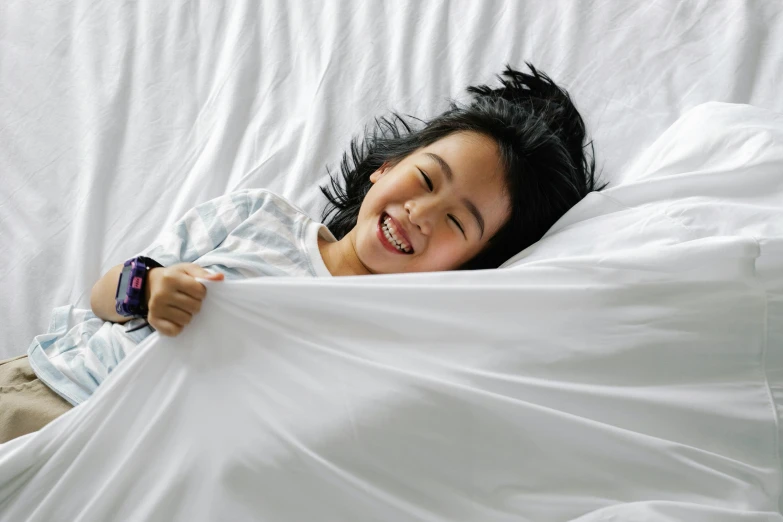 a little girl that is laying in a bed, inspired by Yu Zhiding, happening, premium quality, jakarta, laughing, wind - swept
