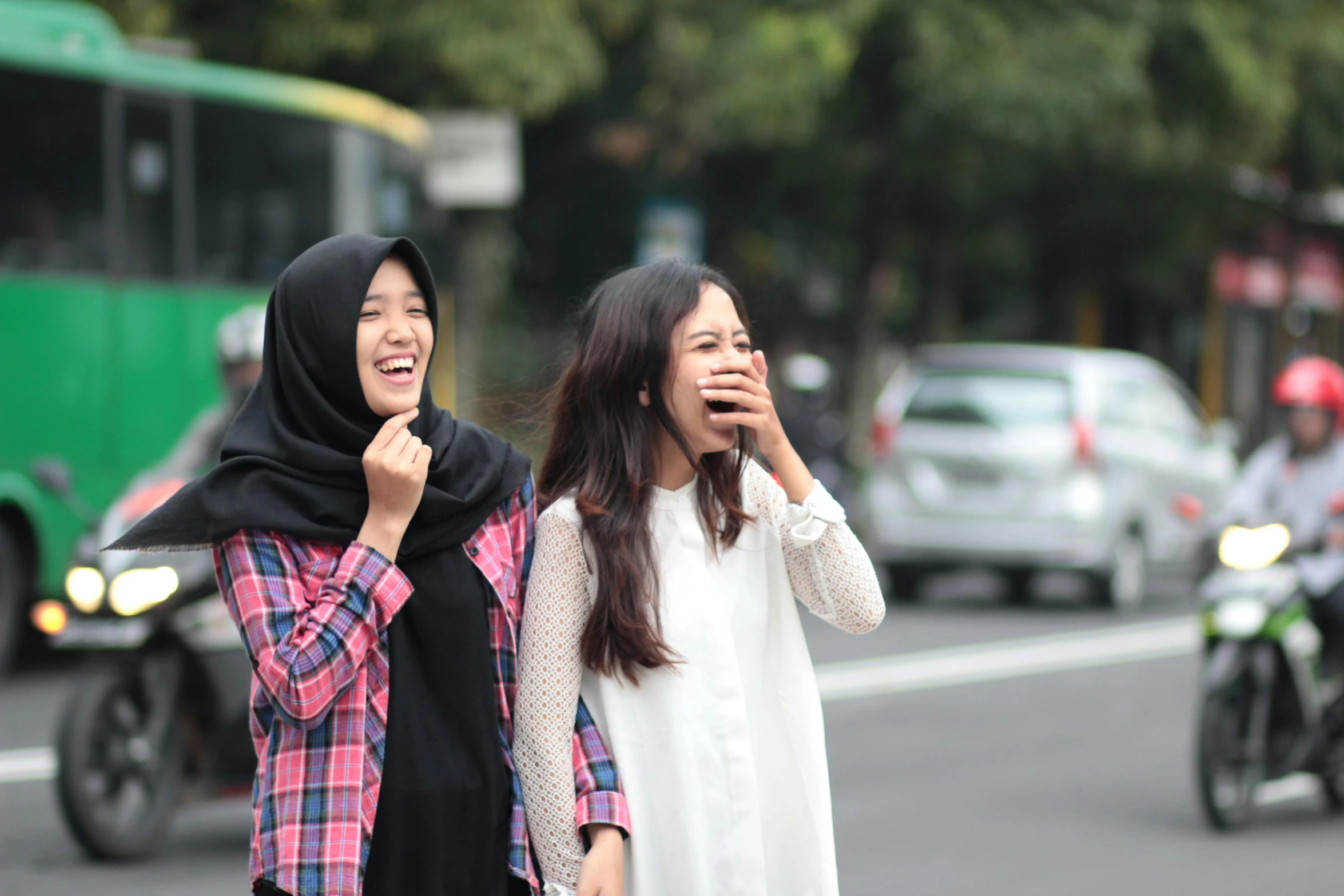 a couple of women standing next to each other on a street, by Bernardino Mei, unsplash, happening, mutahar laughing, maxis, meme, iu