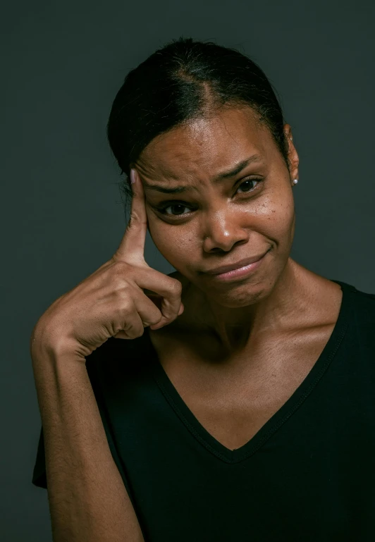 a woman with a concerned look on her face, photo of a black woman, frustrated face, dark backdrop, promo image