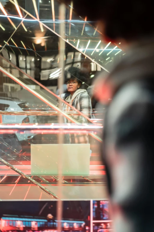 a man standing in front of a glass display case, by Dennis Flanders, trending on unsplash, escalators, admiring her own reflection, thumbnail, donald glover as miles morales