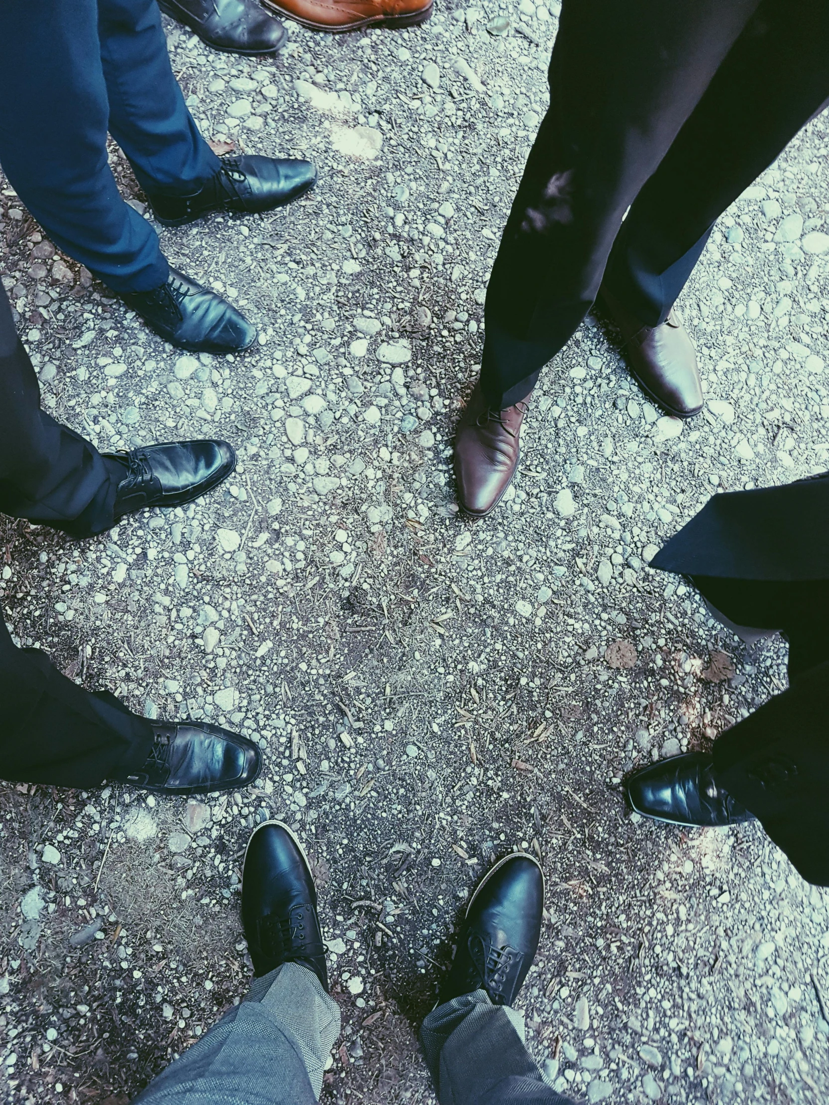 a group of people standing in a circle, an album cover, pexels contest winner, black shoes, ( ( theatrical ) ), iphone photo, blues