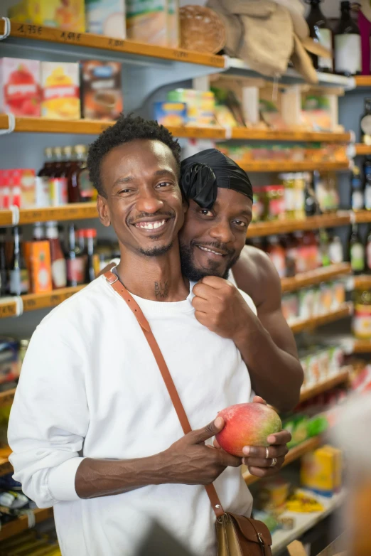 a couple of men standing next to each other in a store, pexels contest winner, renaissance, fruit celebrity, brown skin, embracing, gay pride