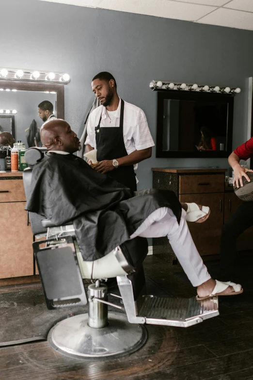 a barber cutting a man's hair in a barber shop, teddy fresh, huell babineaux, still frame, posed