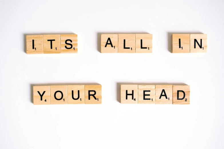wooden blocks spelling it's all in your head, letterism, ad image, head and body, forehead only, headroom