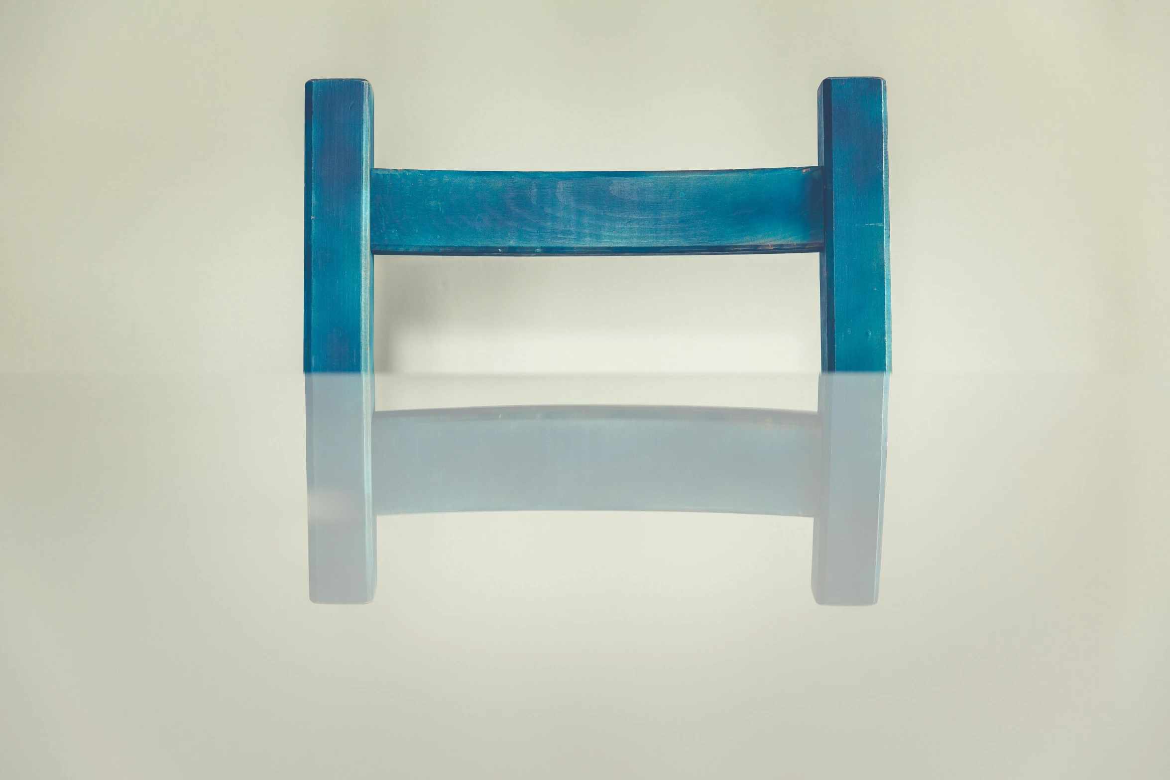 a blue chair sitting on top of a white floor, an abstract sculpture, unsplash, clear reflection, torii, miniature product photo, bench