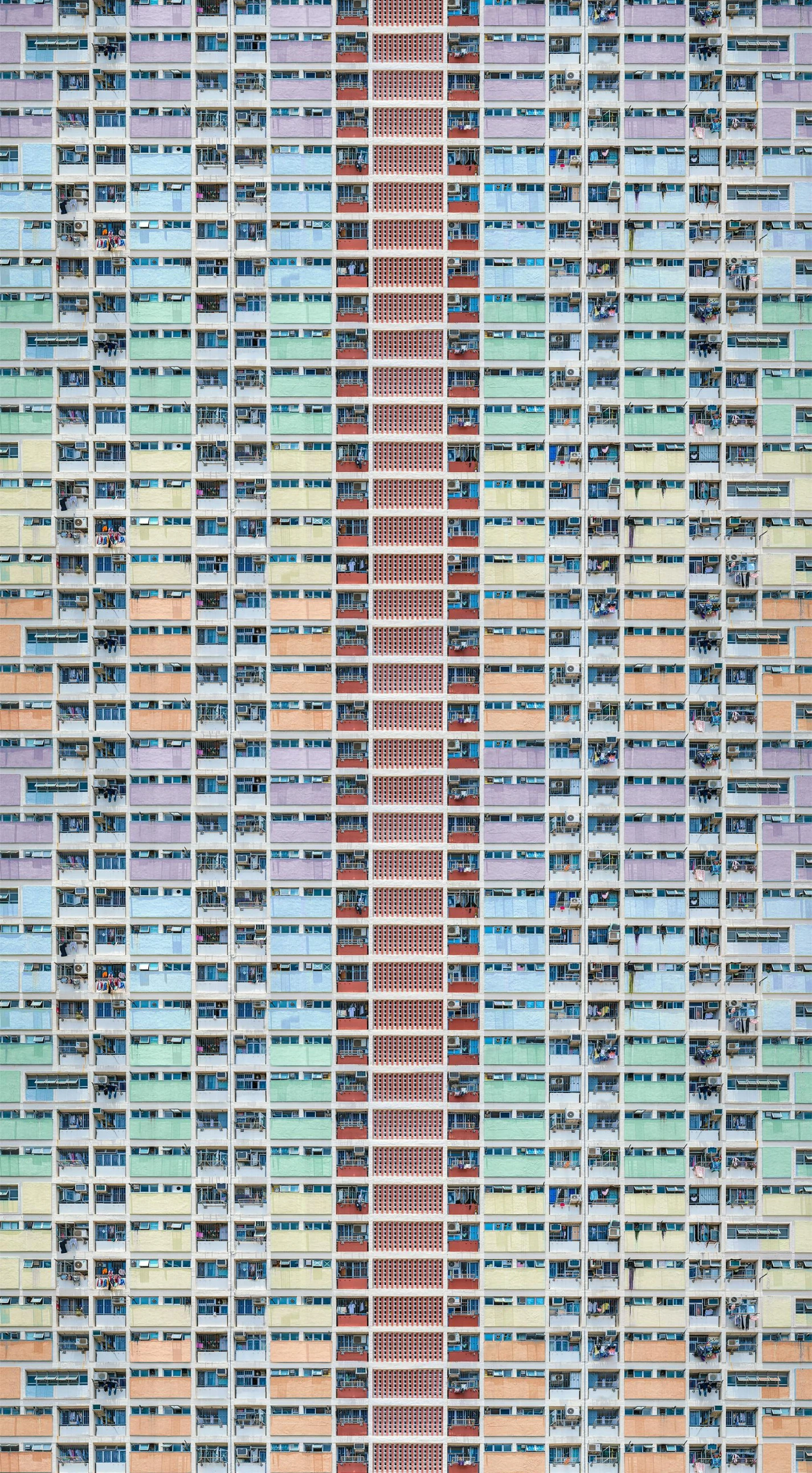 a tall multicolored building with lots of windows, inspired by Andreas Gursky, unsplash contest winner, hyperrealism, bo xun ling, pastelcolours, horizontally symmetrical, hyperrealism photo