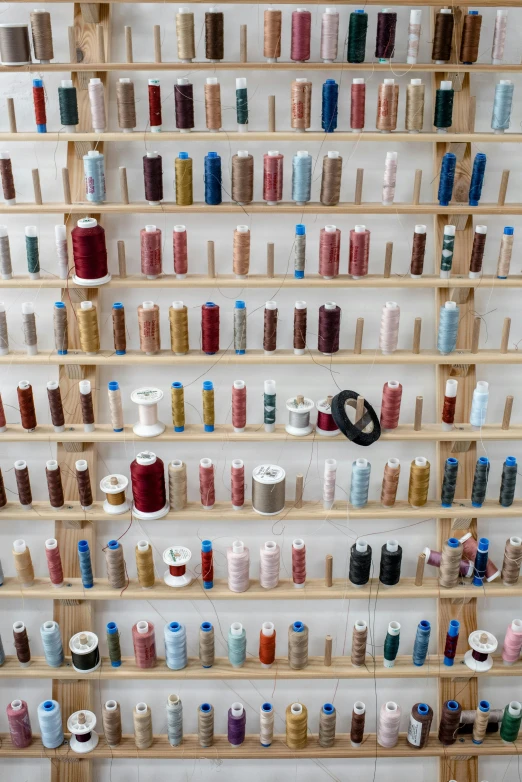 a wall filled with lots of spools of thread, a cross stitch, inspired by Andreas Gursky, unsplash, photographed for reuters, vials, shelf, sequins