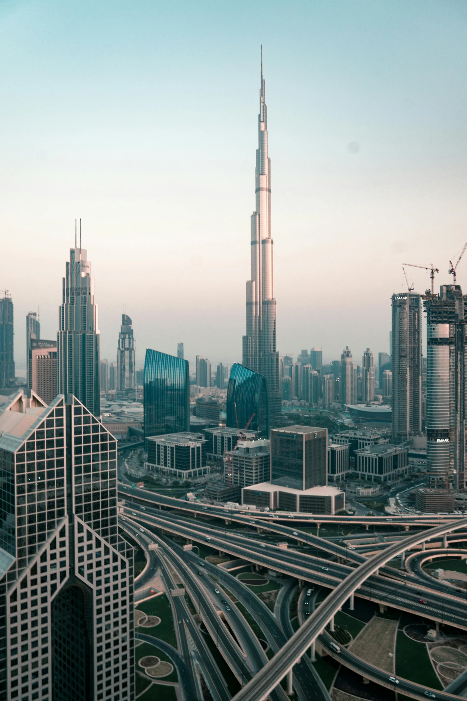 a view of a city from the top of a building, pexels contest winner, hurufiyya, dubai, tall buildings in background, tall spires, movie photo