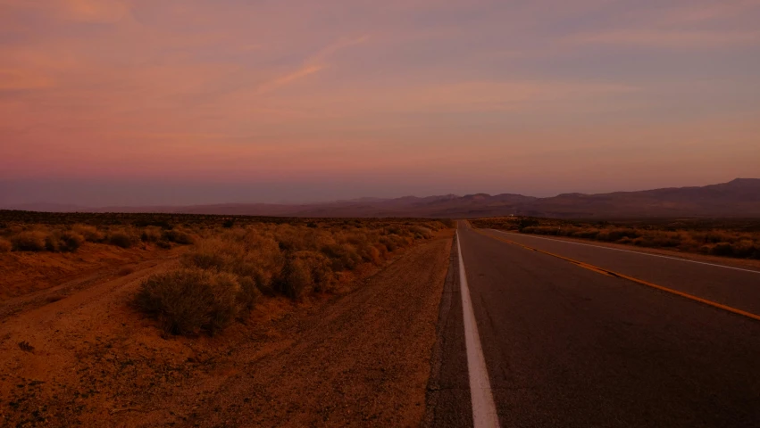 an empty road in the middle of the desert, unsplash contest winner, realism, orange / pink sky, background image, oregon trail, late summer evening