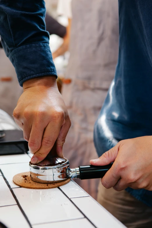 a close up of a person using a cookie cutter, an etching, coffee shop, tending on arstation, performance, brown