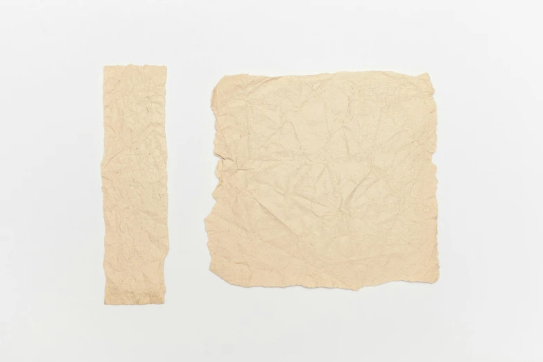 two pieces of paper sitting on top of each other, by Joseph Beuys, unsplash, conceptual art, square shapes, beige, scrolls, skin texture