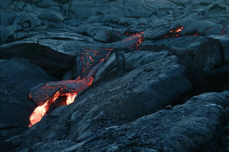 lava flowing down the side of a mountain at night, an album cover, pexels contest winner, hurufiyya, high resolution coal texture, grey, real engine 5 cinematic, rocky ground