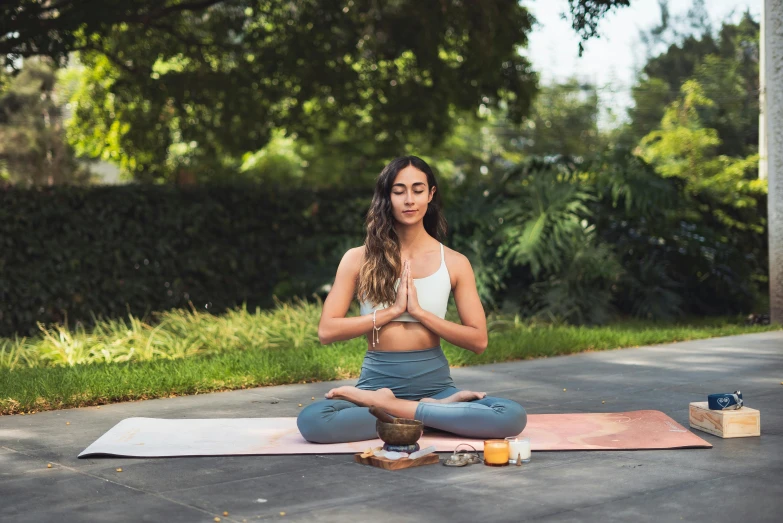 a woman sitting on a yoga mat doing yoga, by Alice Mason, pexels contest winner, happening, lush surroundings, julia sarda, sitting with wrists together, avatar image