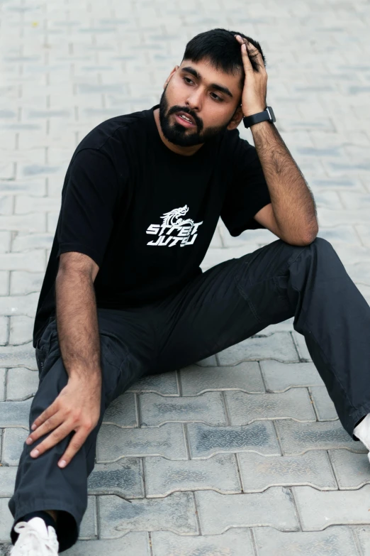 a man sitting on the ground with a skateboard, inspired by Manjit Bawa, hurufiyya, wearing black tshirt, official store photo, sus guy, detailed product shot