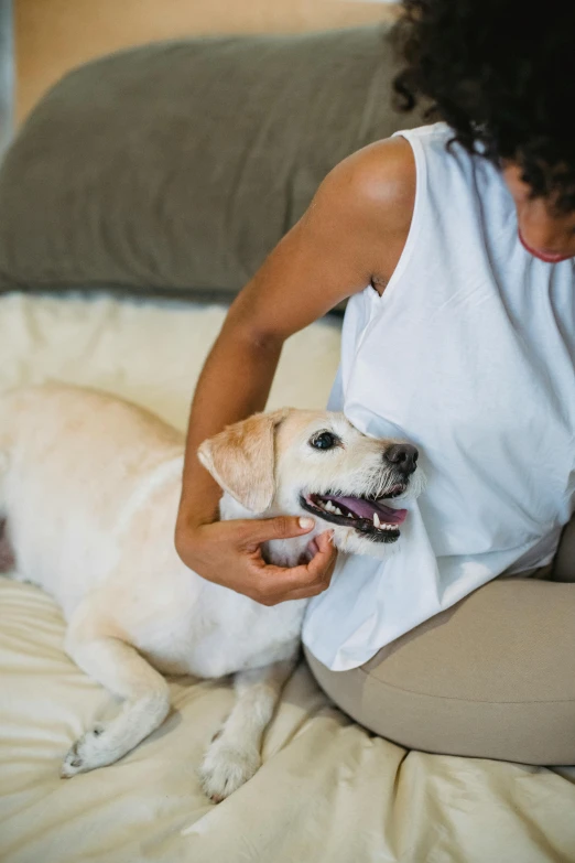 a woman sitting on a bed petting a dog, trending on unsplash, made of lab tissue, dog teeth, white, beige
