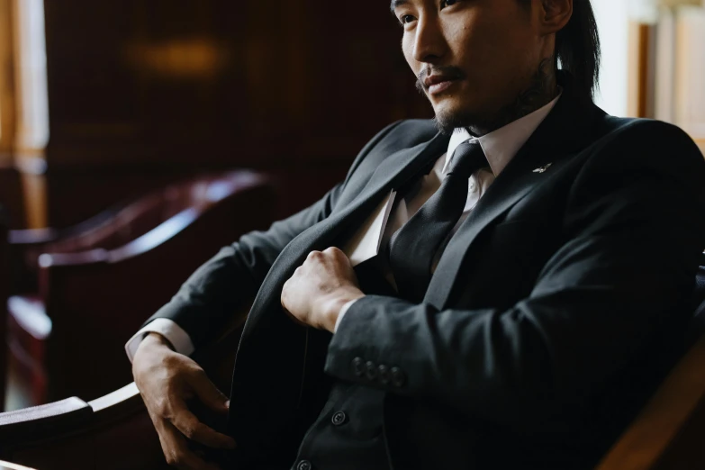 a man in a suit sitting in a chair, trending on pexels, shin hanga, gentleman's club lounge, profile image, half man half asian black bull, androgynous person