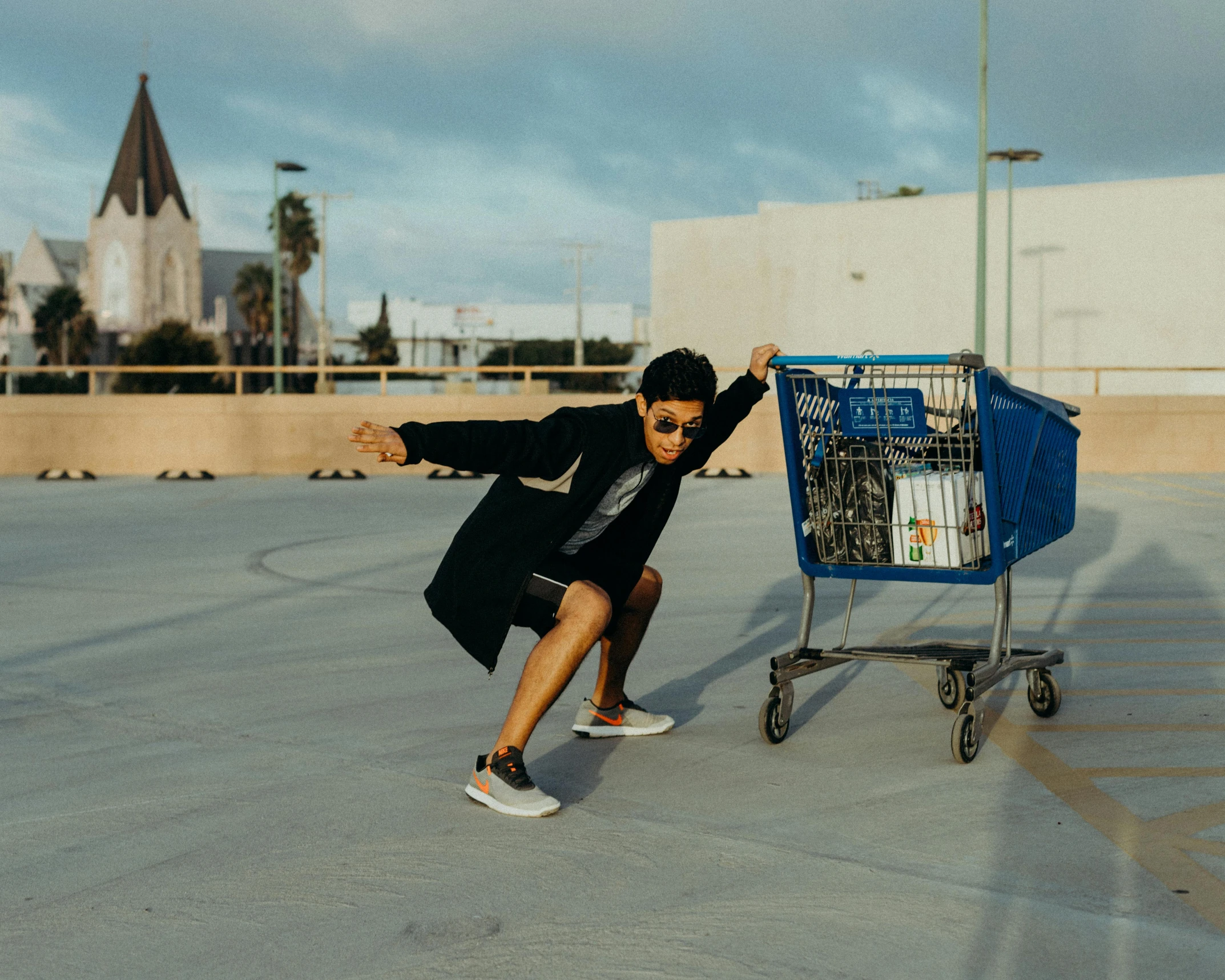 a man riding a skateboard next to a shopping cart, by Julia Pishtar, pexels contest winner, doing a sassy pose, basquiat style, ray william johnson, low quality photo