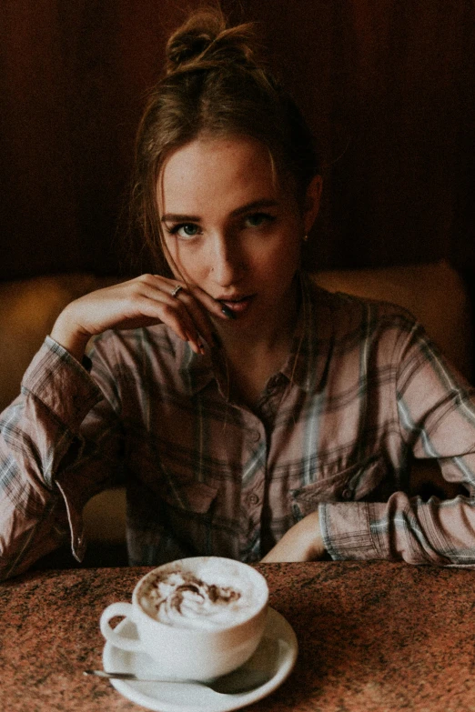 a woman sitting at a table with a cup of coffee, a portrait, by Anna Boch, trending on unsplash, wearing a flannel shirt, britt marling style 3/4, ( waitress ) girl, delicate androgynous prince