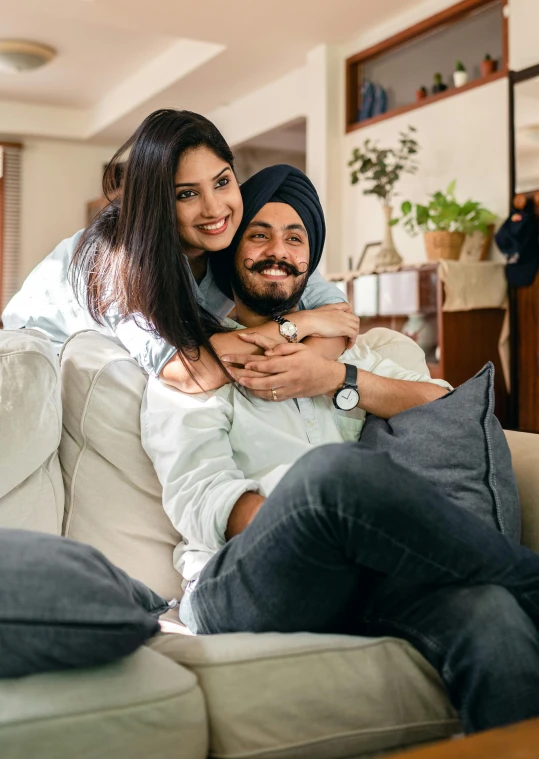 a man and woman sitting on a couch in a living room, inspired by Manjit Bawa, premium quality, hug, thumbnail, asian man