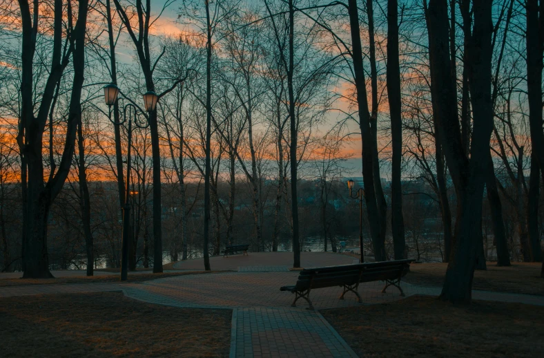 a bench sitting in the middle of a park, inspired by Elsa Bleda, unsplash contest winner, at dusk, magical soviet town, trees outside, instagram post