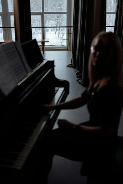 a woman sitting at a piano in front of a window, antipodeans, dramatic lighting - n 9, low quality photo, solo performance unreal engine, winter