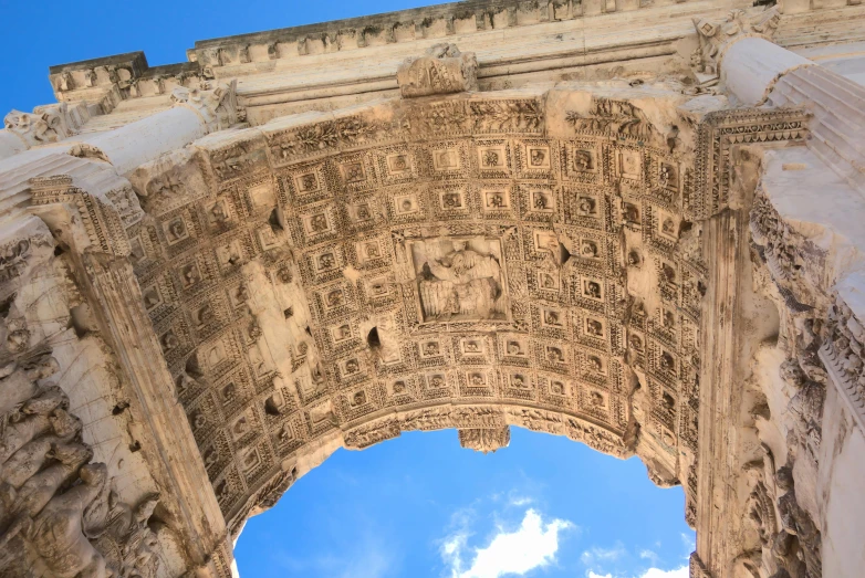 a very tall arch with a blue sky in the background, inspired by Romano Vio, pexels contest winner, neoclassicism, tadema, square, brown, portcullis