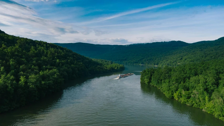 a boat traveling down a river next to a forest, by Daniel Lieske, pexels contest winner, hudson river school, looking over west virginia, container ship, panoramic shot, promo image