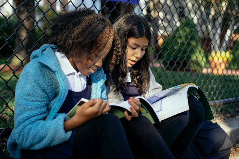 two girls sitting on a bench reading a book, a portrait, trending on unsplash, ashcan school, with book of science, uncropped, thumbnail, te pae