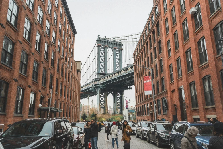 a group of people walking down a street next to tall buildings, high bridges, 🚿🗝📝, brooklyn, big arches in the back