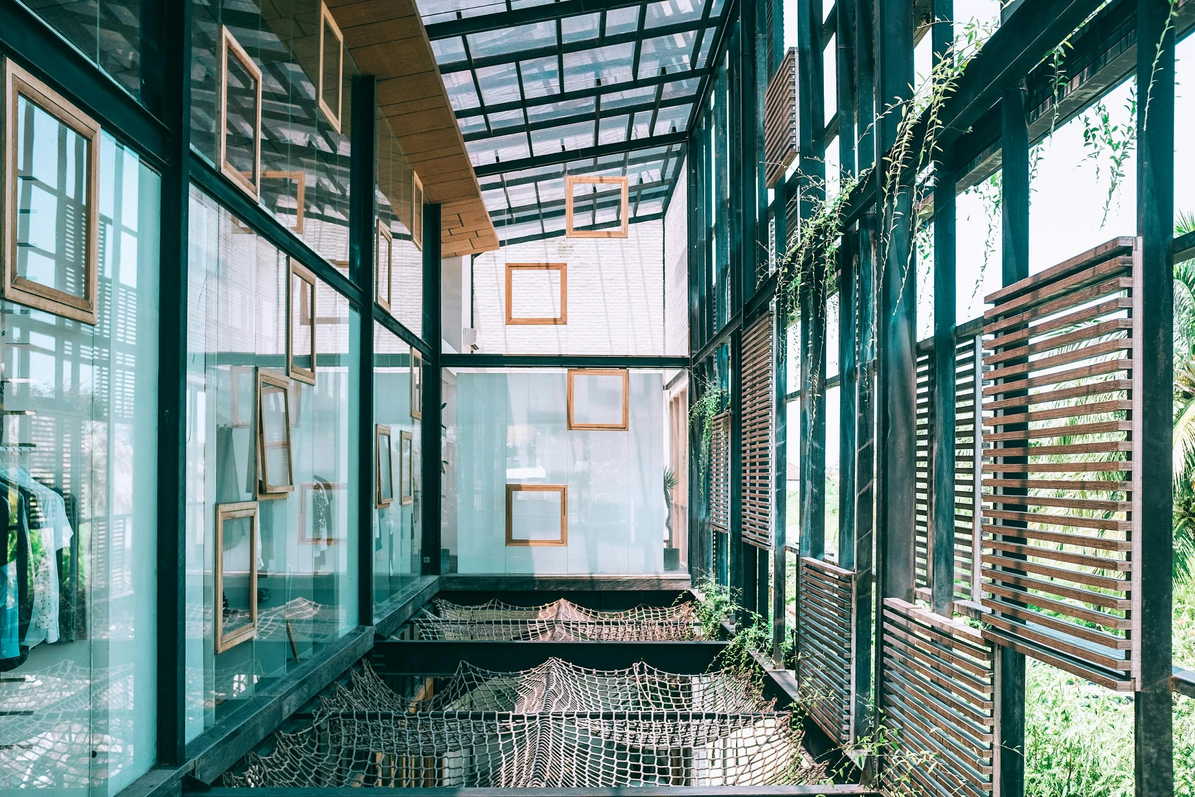 the inside of a building with lots of windows, unsplash, conceptual art, garden behind the glasses, cages, dwell, green alleys