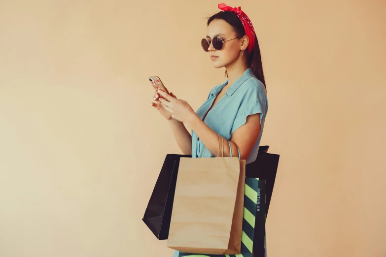 a woman holding shopping bags and looking at her phone, maximalism, retro 5 0 s style, square, no - text no - logo, girl with messy bun hairstyle