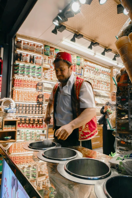 a man standing in front of a counter preparing food, turkish and russian, trending on markets, mate, multiple stories