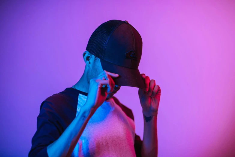 a man holding a cell phone to his ear, inspired by Elsa Bleda, black cap, colorful haze, official product photo, mood light