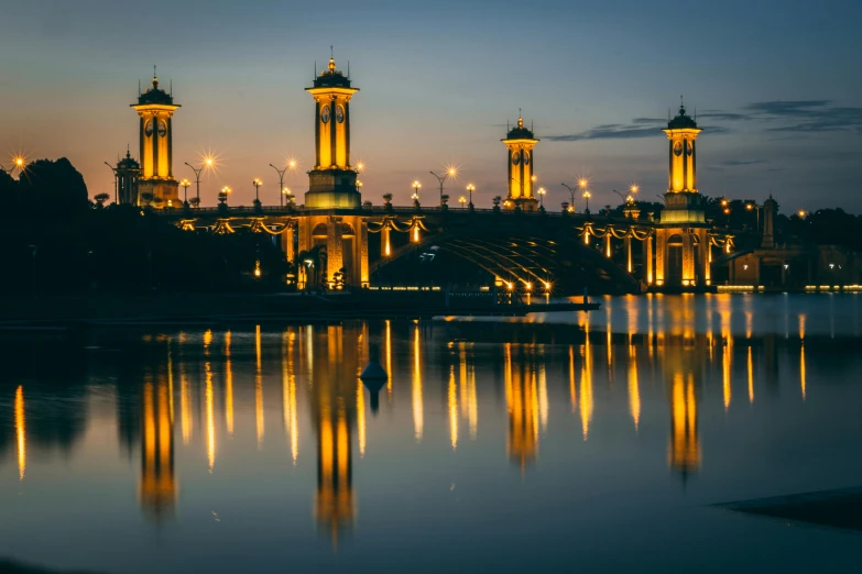 a large building sitting next to a body of water, pexels contest winner, gas lamps, golden pillars, great river, bridge