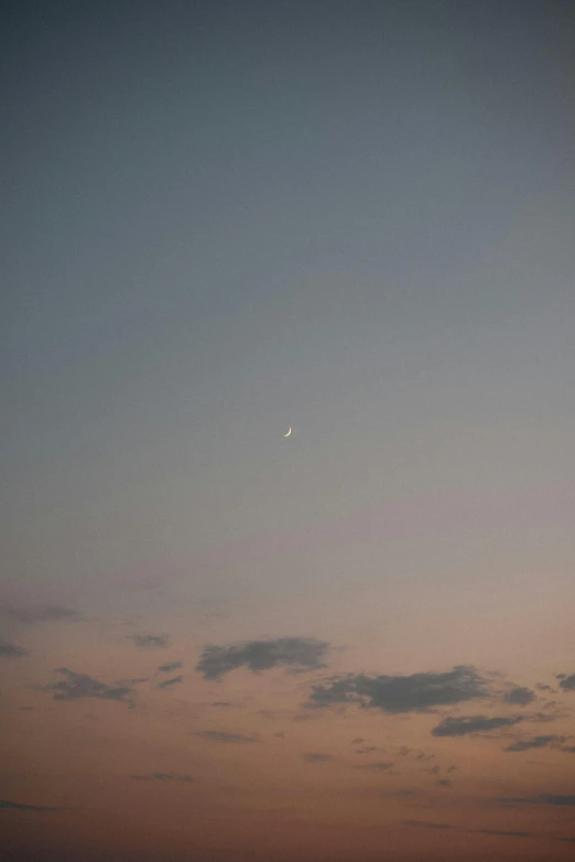 a plane that is flying in the sky, by Attila Meszlenyi, postminimalism, crescent moon, ✨🕌🌙, soft muted colors, ffffound