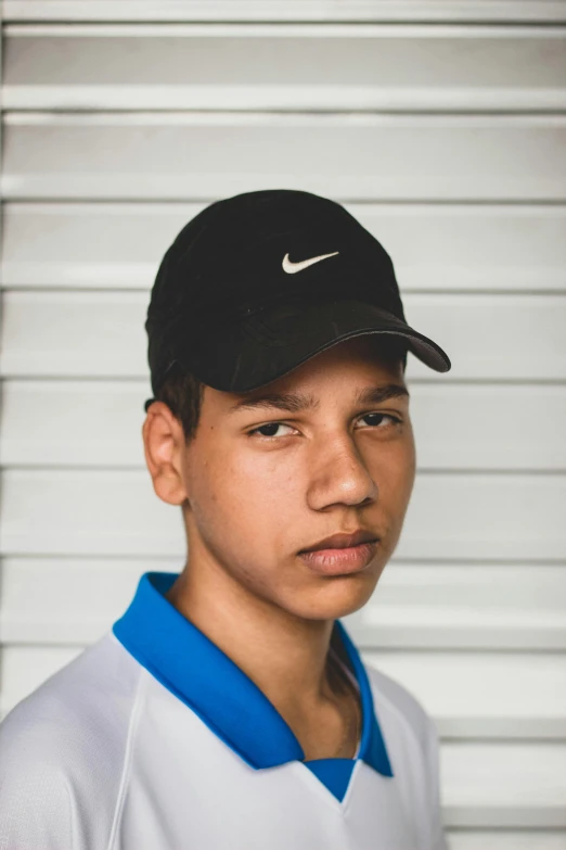 a close up of a person wearing a hat, wearing a baseball cap, ronaldo luis nazario da lima, black teenage boy, profile image