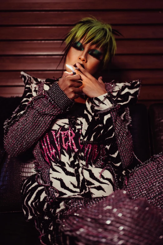 a woman with green hair sitting on a couch, an album cover, trending on pexels, patterned clothing, bedazzled, smoking, she is wearing streetwear