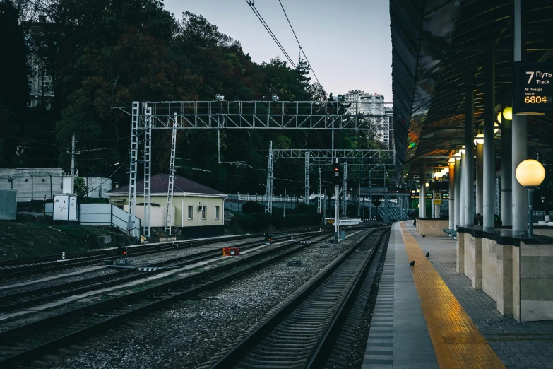 a train station with a train on the tracks, unsplash, sōsaku hanga, square, waiting, sangyeob park, 90's photo