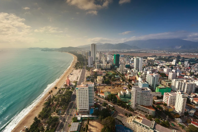 an aerial view of a city next to the ocean, unsplash contest winner, vietnam, square, spanish, profile image