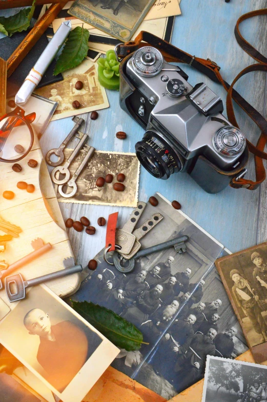 a table topped with old photos and a camera, inspired by Wojciech Gerson, pexels contest winner, assemblage, game cover, key art, high angle close up shot, photograph 4k