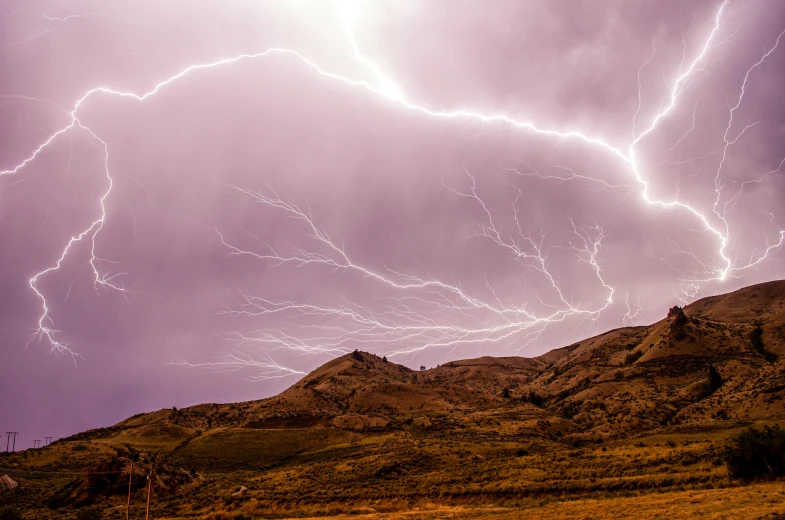 a mountain with a bunch of lightning in the sky, by Peter Churcher, pexels contest winner, hurufiyya, cracks, brown, amanda lilleston, today\'s featured photograph 4k