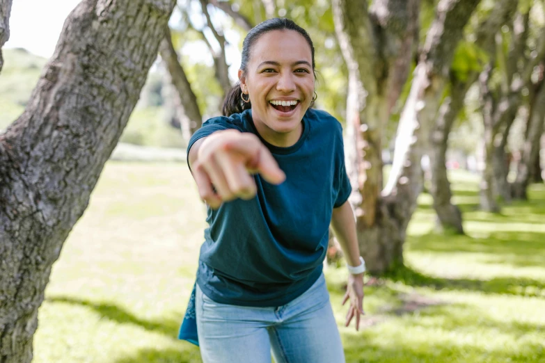 a woman throwing a frisbee in a park, a portrait, pexels contest winner, with pointing finger, wearing a shirt and a jean, laughingstock, avatar image