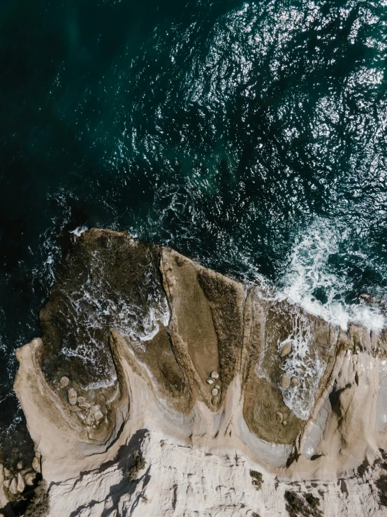 an aerial view of a large body of water, pexels contest winner, happening, rock and sand around, looking threatening, manly, today\'s featured photograph 4k